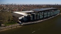 Aerial view of Fulham FCs Craven Cottage stadium redevelopment, Riverside Stand, and Thames riverfront in London.