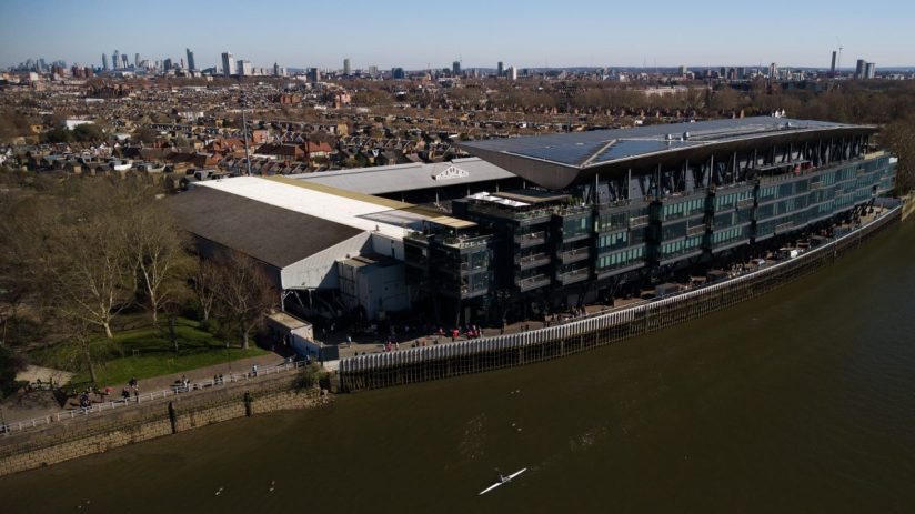 Aerial view of Fulham FCs Craven Cottage stadium redevelopment, Riverside Stand, and Thames riverfront in London.