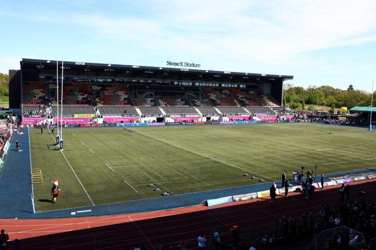 StoneX Stadium, home of Saracens Rugby Club, with empty seats in the stands and a clear green field.