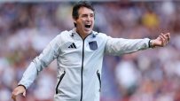 Unai Emery, Aston Villa manager, shouts with intensity during a football match, gesturing with his right arm.