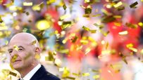 Gianni Infantino, FIFA President, smiling as golden confetti falls around him