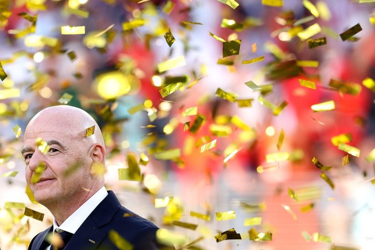 Gianni Infantino, FIFA President, smiling as golden confetti falls around him