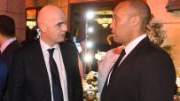 Gianni Infantino speaking with a man in a chefs jacket at a formal event