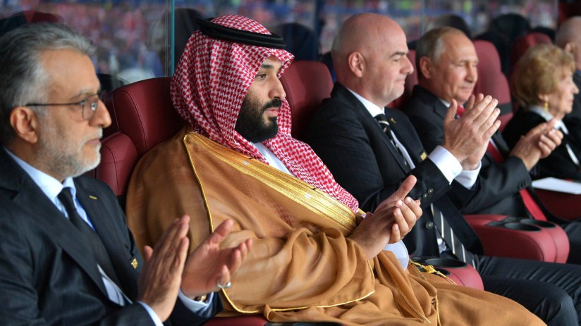Mohammed bin Salman, Gianni Infantino, and Vladimir Putin applauding at an event.