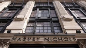 Exterior view of the Harvey Nichols luxury department store building facade with prominent black lettering and ornate arch...