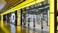 Brightly lit JD Sports store entrance at Meadowhall, showcasing footwear and apparel displays