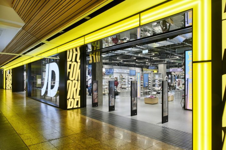 Brightly lit JD Sports store entrance at Meadowhall, showcasing footwear and apparel displays