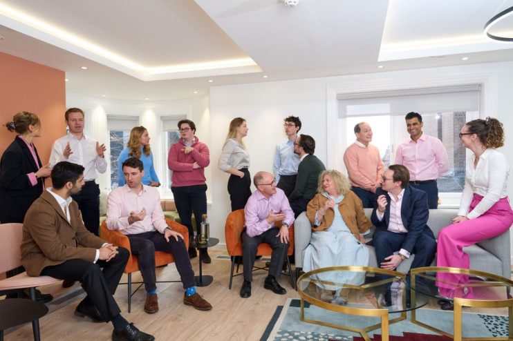 LAVA team collaborating and conversing in a bright, modern office space