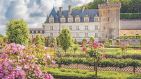Ch&acirc;teau de Villandry in the Loire Valley, France, with its famous ornamental gardens and pink roses in bloom.