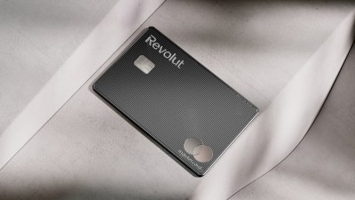 Revolut Mastercard debit card in black with textured lines on a light gray surface