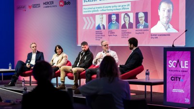 Panelists discuss Scaleup Champions: Capital & Collaboration at SCALEEXPOSUMMIT, with sponsor logos visible.