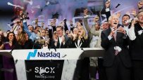 Excited executives celebrating a SpaceX IPO at Nasdaq with confetti falling and fists raised