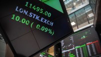 London Stock Exchange digital display showing stock prices, LON.STK.EXCH and green positive change.
