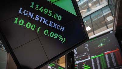 London Stock Exchange digital display showing stock prices, LON.STK.EXCH and green positive change.