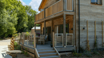 Modern timber-clad holiday lodge in Hampshire with a spacious deck, outdoor dining, and BBQ grill. Perfect UK staycation.