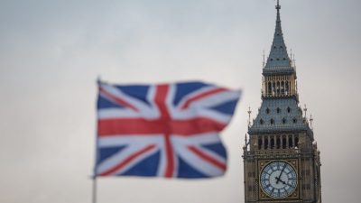 Union Jack flag with Big Ben clock tower and Houses of Parliament in London, UK