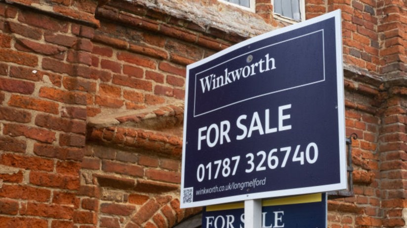 Winkworth estate agent For Sale sign in front of a brick building, indicating property prices and availability.