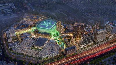 Aerial night rendering of a glowing Dallas Stars NHL arena surrounded by mixed-use buildings, roads, and homes.