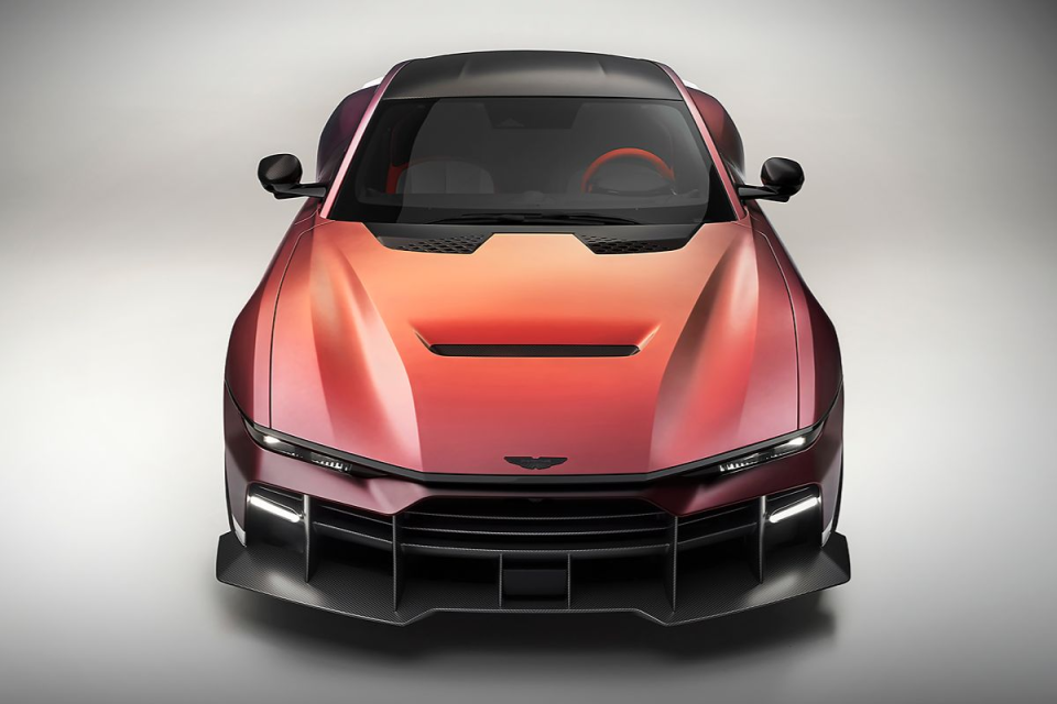 Front view of a red and orange gradient sports car with a carbon fiber splitter and black roof