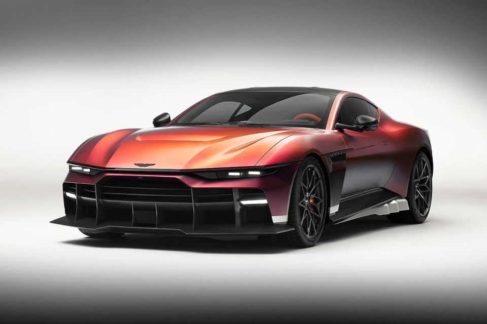 Red and purple metallic sports car with sleek design, black wheels, and aggressive front splitter on a white background