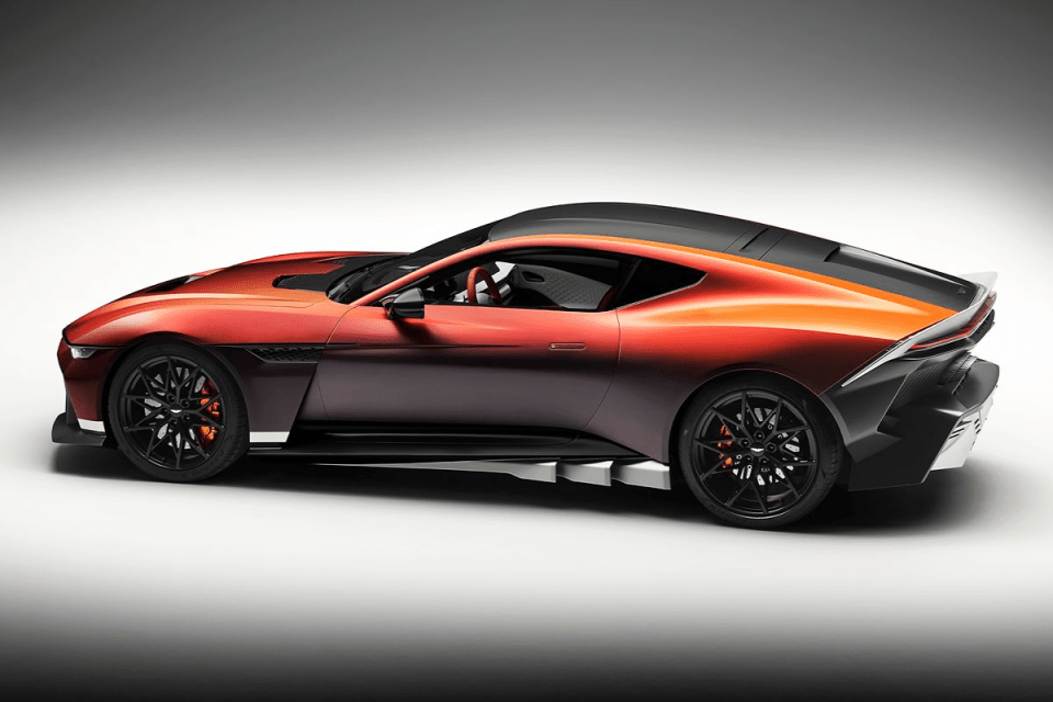 Red and orange luxury sports car, side profile, black wheels with orange brake calipers