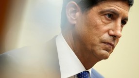 Kevin Warsh, former Fed Governor, in a suit and blue tie, attending Jackson Hole meeting.