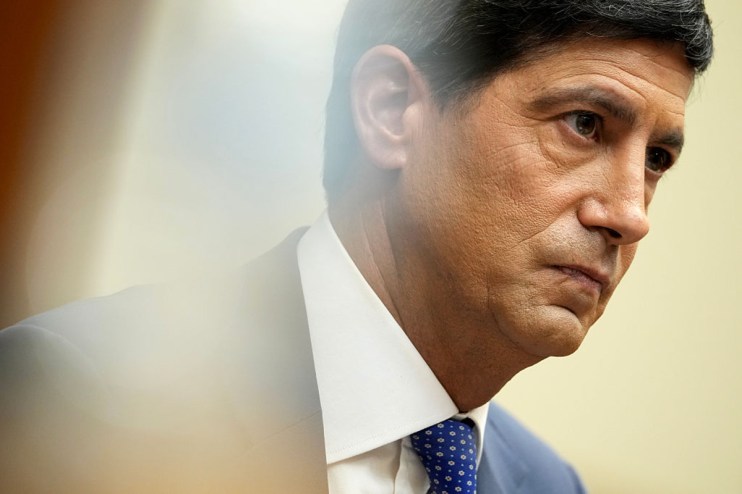 Kevin Warsh, former Fed Governor, in a suit and blue tie, attending Jackson Hole meeting.