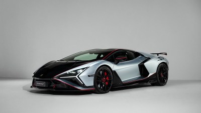 Lamborghini Revuelto SV, a sleek silver and black supercar with red accents, front 3/4 view.