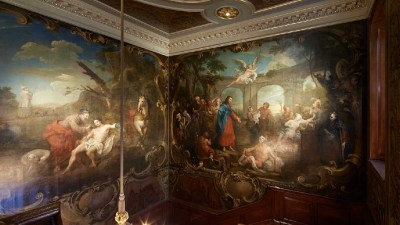 Ornate St. Bartholomews Hospital mural, depicting biblical scenes, on a grand staircase with carved wood and gold trim