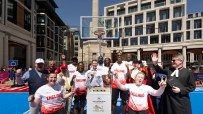 Team England athletes and dignitaries celebrate the Kings Baton Relay for Glasgow 2026 at a London sports festival.