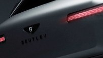 Close-up of a matte dark grey Bentley car with a B logo and red taillights