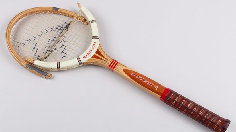Vintage wooden Dunlop Maxply Fort tennis racket with broken strings and frame damage