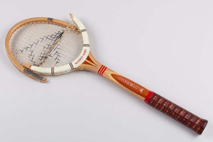 Vintage wooden Dunlop Maxply Fort tennis racket with broken strings and frame damage