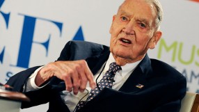 John C. Bogle, Vanguard founder, speaking at a business event, wearing a suit and tie