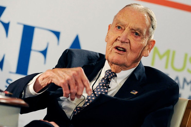 John C. Bogle, Vanguard founder, speaking at a business event, wearing a suit and tie
