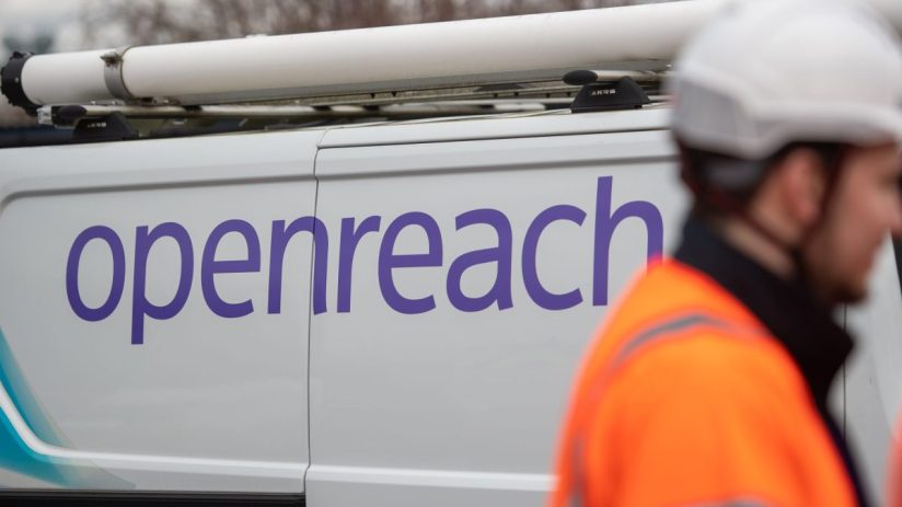 Openreach van with a white roof rack and a worker in an orange high-visibility jacket and white hard hat