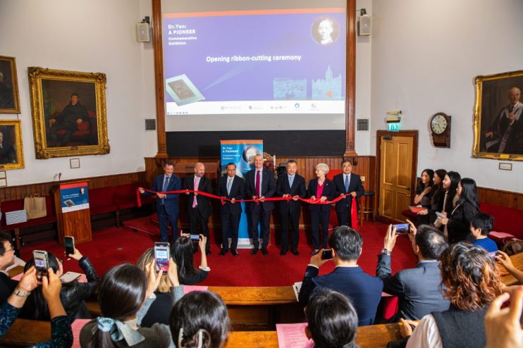 Distinguished guests cutting a red ribbon at the Dr. Yan: A Pioneer Commemorative Exhibition opening ceremony.