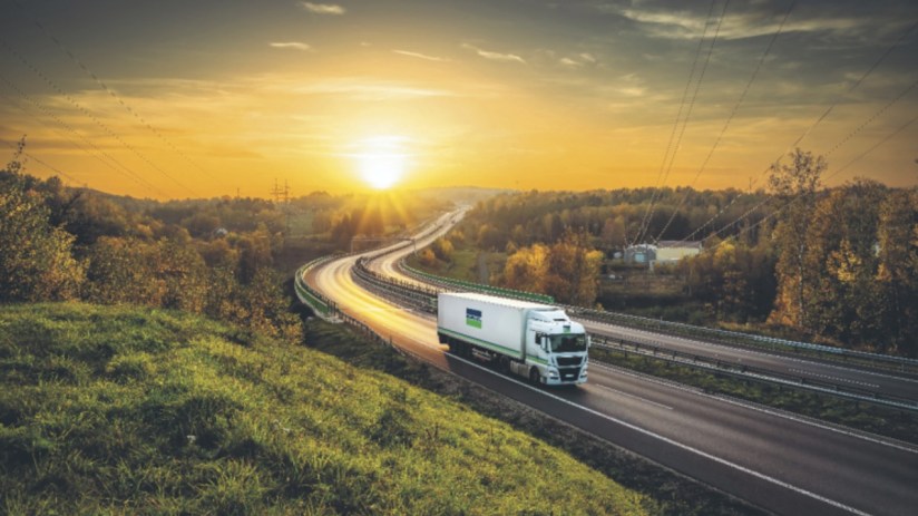 Bunzl lorry with dynamic route planning systems on a highway at sunset
