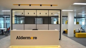 Aldermore Bank reception desk with yellow accents in a modern office interior