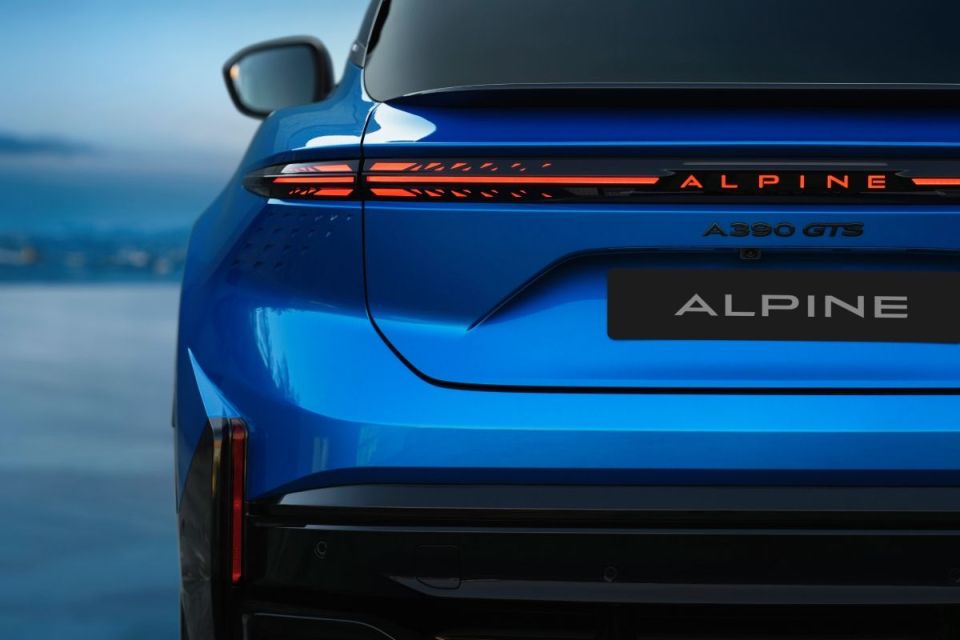 Rear view of a blue Alpine A390 GTS sports car, showcasing its distinctive LED taillights and branding.