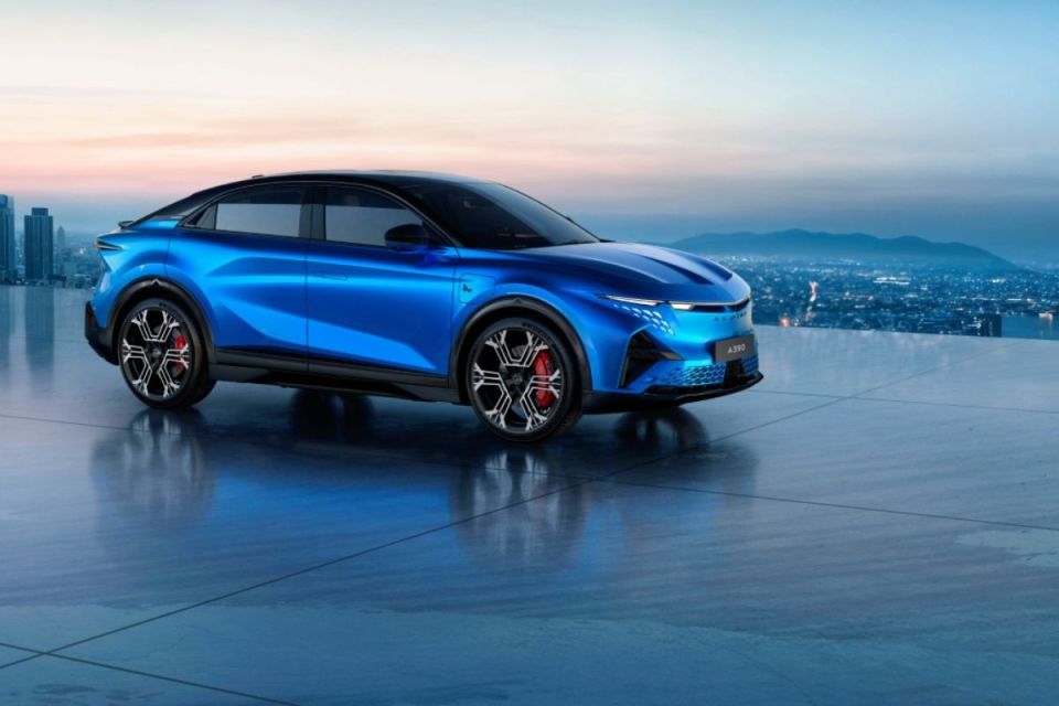 Blue Alpine A390 electric SUV on a modern rooftop overlooking a city skyline at dusk