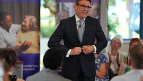 Andy Burnham speaks at Golders Green care home visit, September 2026, engaging with attendees.