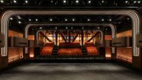 Interior of a modern music venue in London with a stage, tiered seating, and architectural lighting.