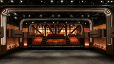 Interior of a modern music venue in London with a stage, tiered seating, and architectural lighting.
