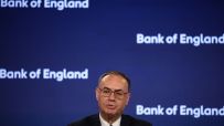 Andrew Bailey, Governor of the Bank of England, speaking at a press conference with the BoE logo in the background.