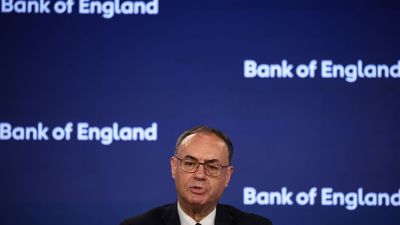 Andrew Bailey, Governor of the Bank of England, speaking at a press conference with the BoE logo in the background.