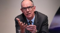 Bank of England Deputy Governor Dave Ramsden speaking, gesturing with hands, wearing glasses and a suit.