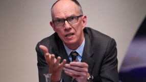 Bank of England Deputy Governor Dave Ramsden speaking, gesturing with hands, wearing glasses and a suit.