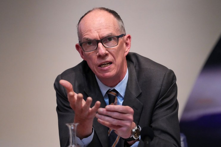 Bank of England Deputy Governor Dave Ramsden speaking, gesturing with hands, wearing glasses and a suit.
