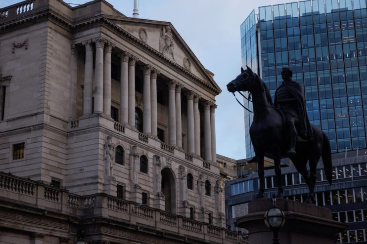 Bank of England facade with classical columns, intricate carvings, and a statue on horseback against a modern glass building.